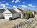 Single-story home with attached garage, landscaping, and a paved driveway at 41071 Calla Lily St, Fort Mill, SC 29707