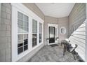 Inviting front porch with tiled flooring and seating area at 41071 Calla Lily St, Fort Mill, SC 29707