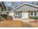 Charming single-story home featuring a gray and white painted brick exterior with a well-maintained front lawn at 4321 Gillespie Ct, Charlotte, NC 28205