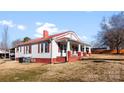 Beautiful exterior view of a well-maintained home with red shutters and a spacious yard at 601 N 12Th St, Bessemer City, NC 28016