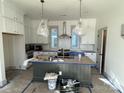 Modern kitchen with white cabinets, a large island, and stylish pendant lights at 718 Barrel Aly, Fort Mill, SC 29715