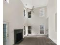 Spacious living room featuring high ceilings and a fireplace at 8200 Suttonview Dr, Charlotte, NC 28269