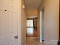 View of living room from entryway with hardwood floors at 8225 Pineville Matthews Rd # H, Charlotte, NC 28226