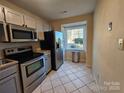 Kitchen with stainless steel appliances and tile floor at 8225 Pineville Matthews Rd # H, Charlotte, NC 28226