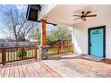 Relaxing covered porch with stained wooden floors, a ceiling fan, and views of the backyard at 8228 Moores Chapel Rd, Charlotte, NC 28214