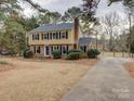 Two-story house with a yellow exterior, blue door, and driveway at 860 Nightingale Rd, Rock Hill, SC 29732