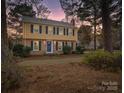 Evening view of a two-story house with a yellow exterior and blue door at 860 Nightingale Rd, Rock Hill, SC 29732