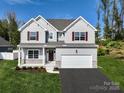 Two-story home with gray siding, maroon shutters, and a white garage door at Lot 113 Mayes Meadow Dr # Savanh, Cornelius, NC 28078