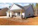 Two-story home with gray siding, wood accents, and a covered porch at 1135 Rudder Cir, Salisbury, NC 28146