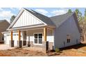 Angled view of single-story house with stone accents and timber columns supporting covered porch at 1135 Rudder Cir, Salisbury, NC 28146