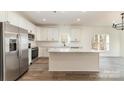 Modern kitchen with white cabinets, granite countertops, and stainless steel appliances at 1135 Rudder Cir, Salisbury, NC 28146