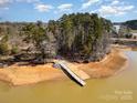 Waterfront view of a private dock and launch for enjoying lake activities surrounded by lush greenery and calm waters at 1135 Rudder Cir, Salisbury, NC 28146