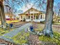 House with a flag, stone walkway, and mature trees at 12 Maple St, Great Falls, SC 29055