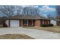 Brick ranch house with a white garage door and a long driveway at 125 1St N Ave, Conover, NC 28613