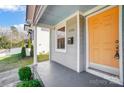 Inviting orange front door with gray siding at 1715 Dunkirk Dr, Charlotte, NC 28203