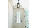 Bright foyer featuring a glass front door, modern light fixture, white trim, and neutral wall color at 1912 St John St, Charlotte, NC 28216