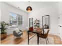 Bright home office with a large window, desk, chair, and built-in shelving at 1912 St John St, Charlotte, NC 28216