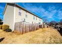 Townhouse backyard with wooden fence, patio, and satellite dishes at 217 22Nd Sw St # H, Hickory, NC 28602