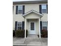 Two-story beige vinyl sided building with black trimmed windows and a covered entry at 217 22Nd Sw St # H, Hickory, NC 28602