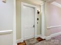 Residential hallway with a white door and neutral wall color at 2223 Croydon Rd # 103, Charlotte, NC 28207