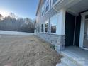 Side yard with stone accents and landscaping at 284 Laura Elizabeth Ln, Clover, SC 29710