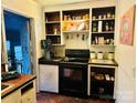 Galley kitchen with wood cabinets and black appliances at 309 York Rd, Kings Mountain, NC 28086