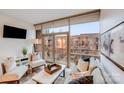 Bright living room with large windows, neutral colors, and balcony access at 315 Arlington Ave # 607, Charlotte, NC 28203