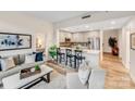 Open-concept living room and kitchen featuring an island, barstool seating, and neutral colors at 315 Arlington Ave # 607, Charlotte, NC 28203