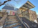 Stone house exterior with a covered porch and steps leading up to the entrance at 330 E Main St, Albemarle, NC 28001