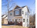 Two-story house with gray siding, brick accents, and a green door at 3739 Kennedy Rd, Gastonia, NC 28056