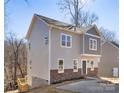 Two-story house with gray siding, brick accents, and a green door at 3739 Kennedy Rd, Gastonia, NC 28056