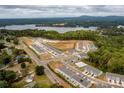 Stunning aerial view of a well-planned community near a lake, surrounded by lush greenery and offering various amenities at 4134 Steel Way, Sherrills Ford, NC 28673