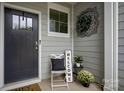 Inviting front porch with a dark gray door and welcoming decor at 4134 Steel Way, Sherrills Ford, NC 28673