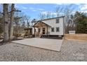 Side view of a modern farmhouse with a concrete patio surrounded by landscaped gravel at 4747 Kenneths Dr, Maiden, NC 28650