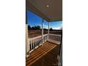 Inviting front porch with wood floors, white railings, and views of the surrounding landscape at 507 E Lackey Farm Rd, Stony Point, NC 28678