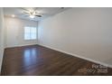 Living room with hardwood floors, neutral walls and door access at 6340 Revolutionary Trl, Charlotte, NC 28217