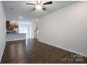 Spacious living room with hardwood floors and kitchen view at 6340 Revolutionary Trl, Charlotte, NC 28217