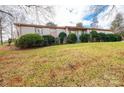 Brick ranch house with landscaped lawn and mature shrubs at 641 20Th Avenue Nw Dr, Hickory, NC 28601