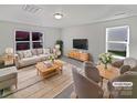 Virtually staged living room featuring a neutral color palette and ample natural light at 6621 Pennacook Dr, Charlotte, NC 28214