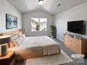 Virtually staged main bedroom with a king-size bed and light wood dresser at 6621 Pennacook Dr, Charlotte, NC 28214