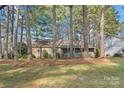 Exterior view of a charming single-story home with a well-manicured lawn and plenty of trees at 709 Falls Church Rd, Charlotte, NC 28270