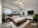 Spacious main bedroom with large windows and wood floors at 7129 Spandril Ln, Charlotte, NC 28215