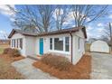 Brick ranch home with teal door, landscaping, and detached shed at 809 Hasty Rd, Marshville, NC 28103