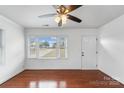 Bright living room featuring hardwood floors, large window, and ceiling fan at 809 Hasty Rd, Marshville, NC 28103