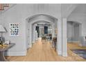 Bright foyer with hardwood floors and arched entryways leading to other rooms at 8904 Clavemorr Glenn Ct, Charlotte, NC 28226