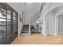 Elegant staircase with a metal railing and plaid runner, creating a welcoming feel at 8904 Clavemorr Glenn Ct, Charlotte, NC 28226