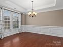 Formal dining room with hardwood floors, crown molding, and a chandelier at 1010 Craven St, Indian Trail, NC 28079
