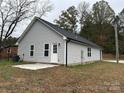 Rear view of gray house, showing a small patio at 103 Harley St, Wadesboro, NC 28170