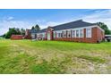 Brick building with large windows and a spacious yard at 1318 Ostwalt Amity Rd, Cleveland, NC 27013