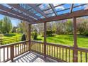 A beautiful backyard featuring lush green grass and a cozy pergola-covered deck at 14500 Harvington Dr, Huntersville, NC 28078